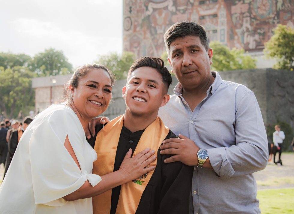 A graduate celebrating with family after commencement
